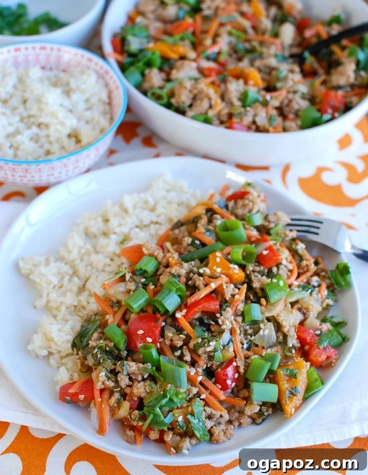 Easy Thai Pork Stir-Fry being cooked in a large skillet, showing browned ground pork and colorful vegetables.