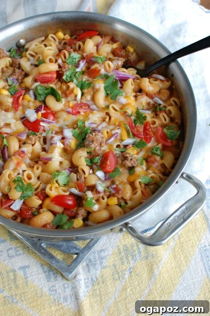 Easy One-Pan Taco Beef Pasta 4 Close-up side view of One Skillet Beef Taco Pasta garnished with fresh ingredients