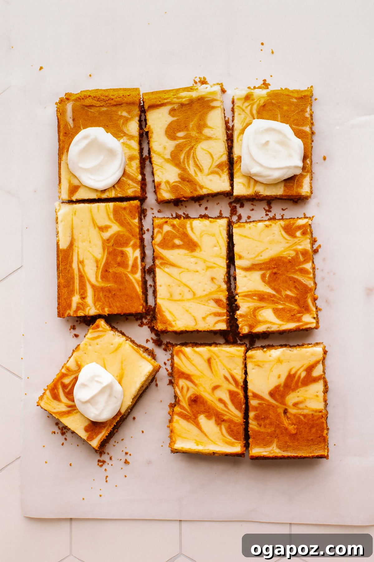 Delicious Pumpkin Cheesecake Bars topped with a dollop of whipped cream, ready to be served.