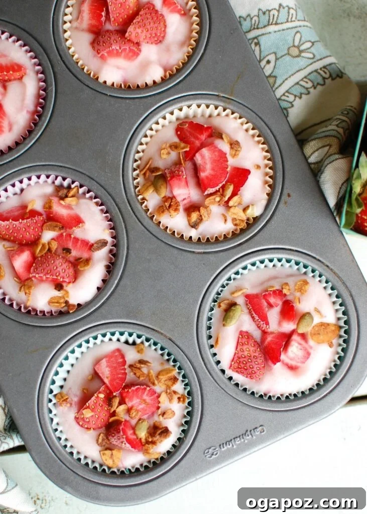Fro-Yo Granola Clusters 5 A muffin tin filled with Frozen Yogurt Granola Bites, ready to be placed in the freezer.