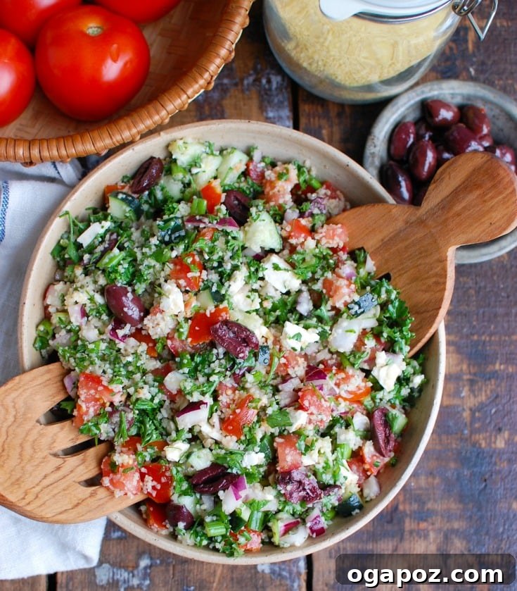 Vibrant Greek Tabbouleh Salad 3 Greek Tabbouleh salad with serving spoons in a rustic bowl.