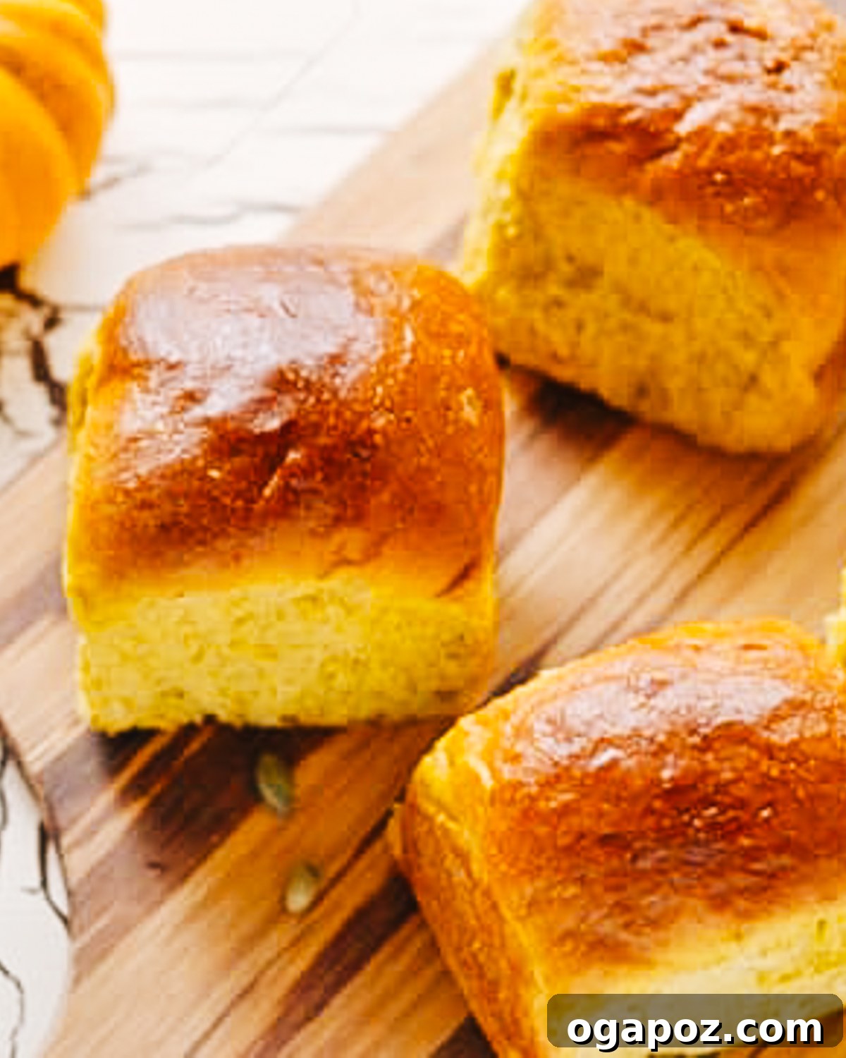 Harvest Pumpkin Rolls 2 Golden-brown, soft, and fluffy Pumpkin Dinner Rolls arranged on a baking sheet, ready to be served.