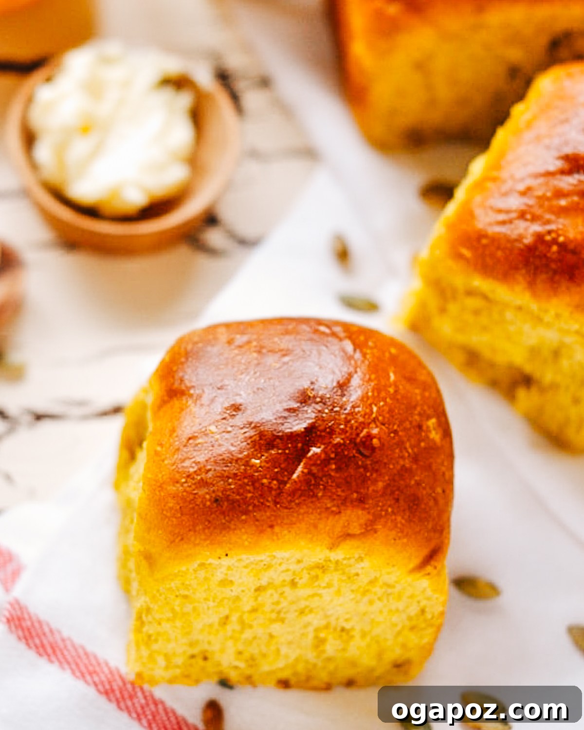 Harvest Pumpkin Rolls 4 A close-up shot of baked pumpkin dinner rolls, showcasing their golden crust and tender interior.