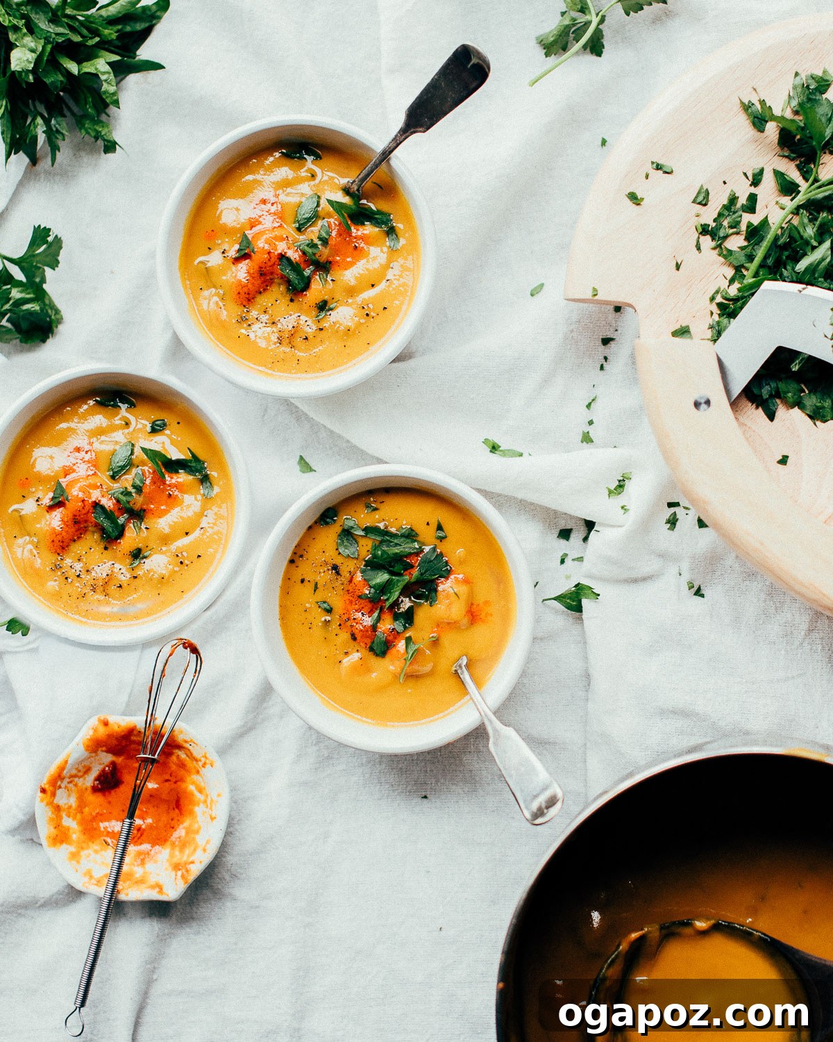 Golden Spiced Carrot Ginger Comfort 2 Two bowls of vibrant Spiced Carrot Ginger Soup garnished with a swirl of yogurt and fresh herbs.