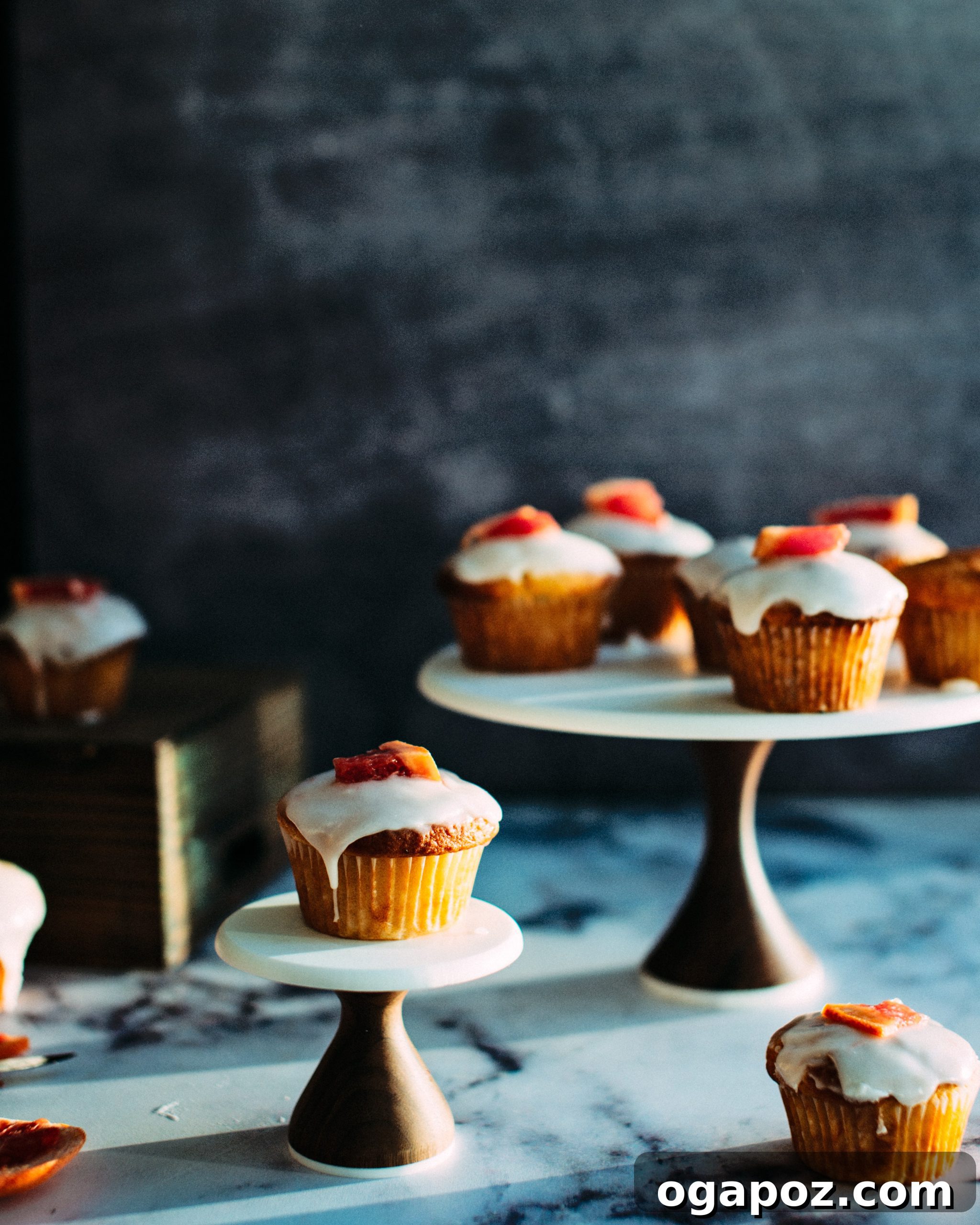 Pink Grapefruit Yogurt Gems 4 A stack of Grapefruit Yogurt Muffins, elegantly presented with a sprig of rosemary.