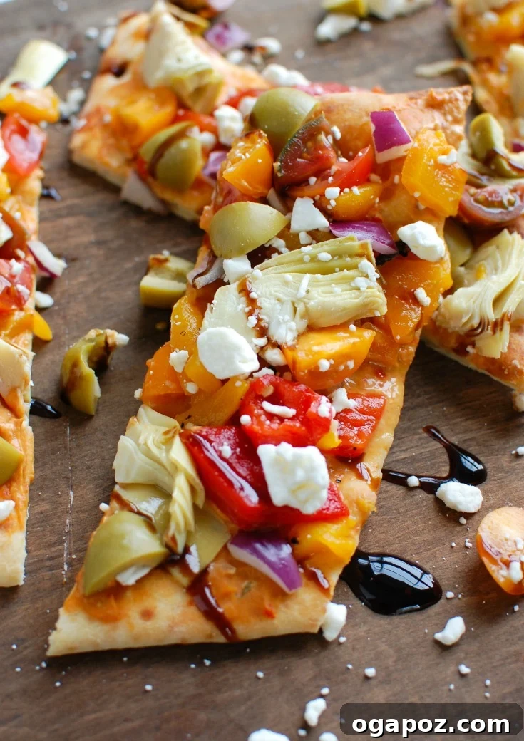 Sun-Drenched Mediterranean Flatbread 7 A single slice of Mediterranean Flatbread, showcasing its delicious layers and crisp crust.