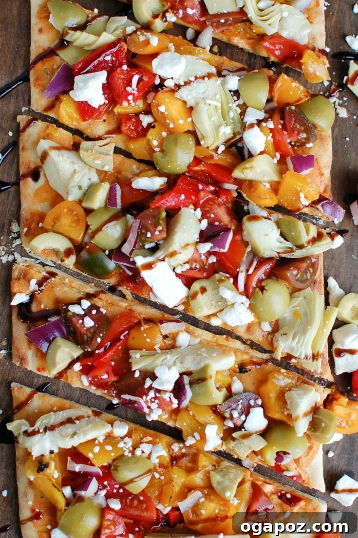 Sun-Drenched Mediterranean Flatbread 8 A beautifully presented Mediterranean Flatbread, emphasizing its vibrant colors and delicious components, suitable for an appetizer or light meal.