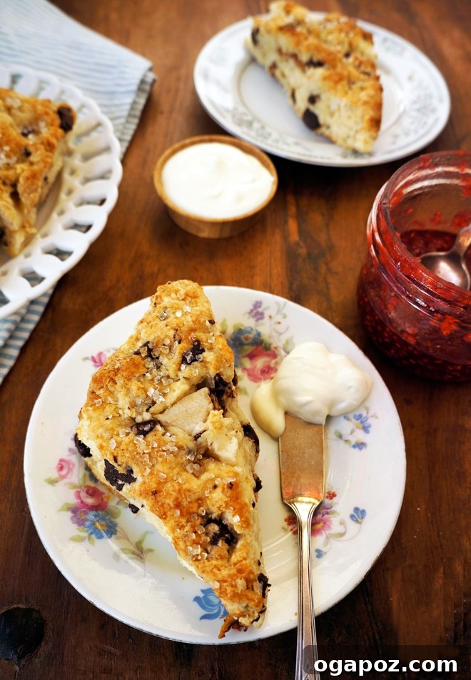 Decadent Ginger Pear Scones with Dark Chocolate 3 A close-up shot of Dark Chocolate Ginger Pear Scones on a plate, ready to be served with creme fraiche.