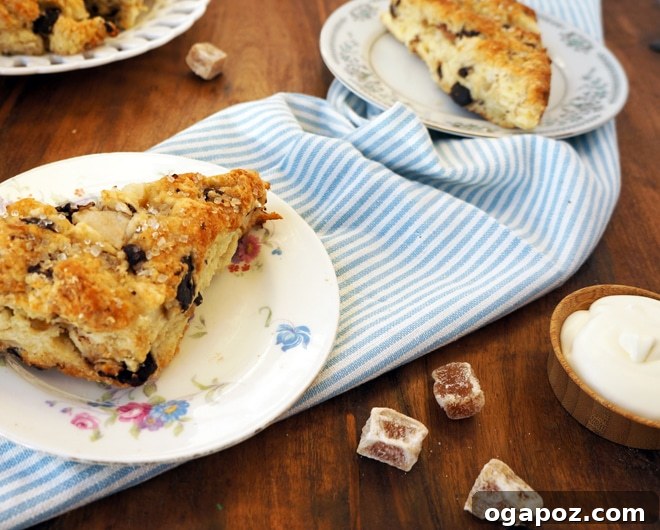 Decadent Ginger Pear Scones with Dark Chocolate 4 Scone dough being gently pressed together on a floured surface, showing the shaggy texture before kneading.