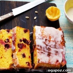 Vibrant Cranberry Lemon Cake with Zesty Glaze 6 A close-up of the slice of Cranberry Lemon Loaf, showing texture and cranberries.