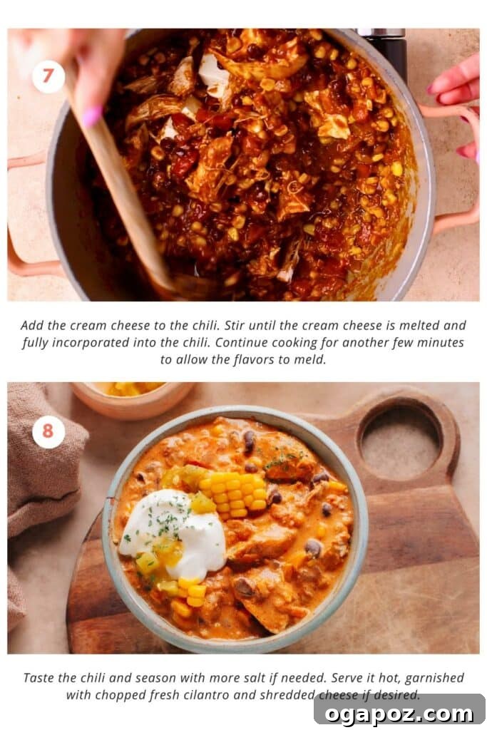 Velvet Chicken Chili 7 Softened cream cheese cubes gently melting into the hot, spiced chicken chili, creating a luscious and creamy texture.