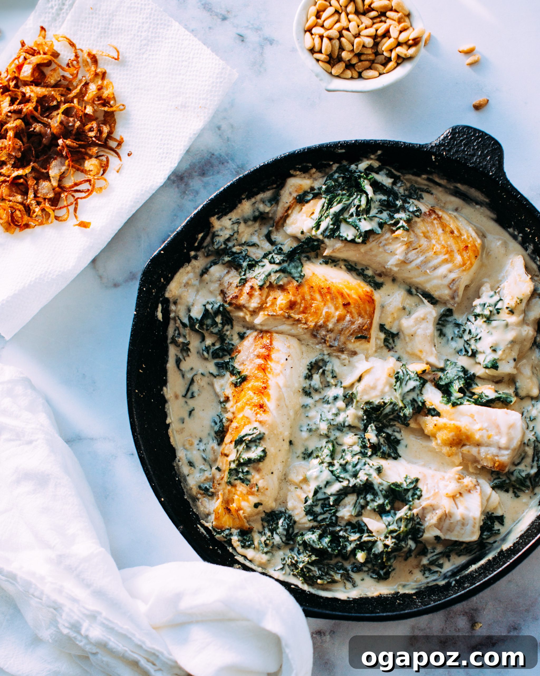 Creamy Tahini Fish and Kale with Golden Crispy Shallots 2 Delicious pan-seared white fish and vibrant kale in a creamy tahini sauce, garnished with golden crispy shallots and pine nuts.