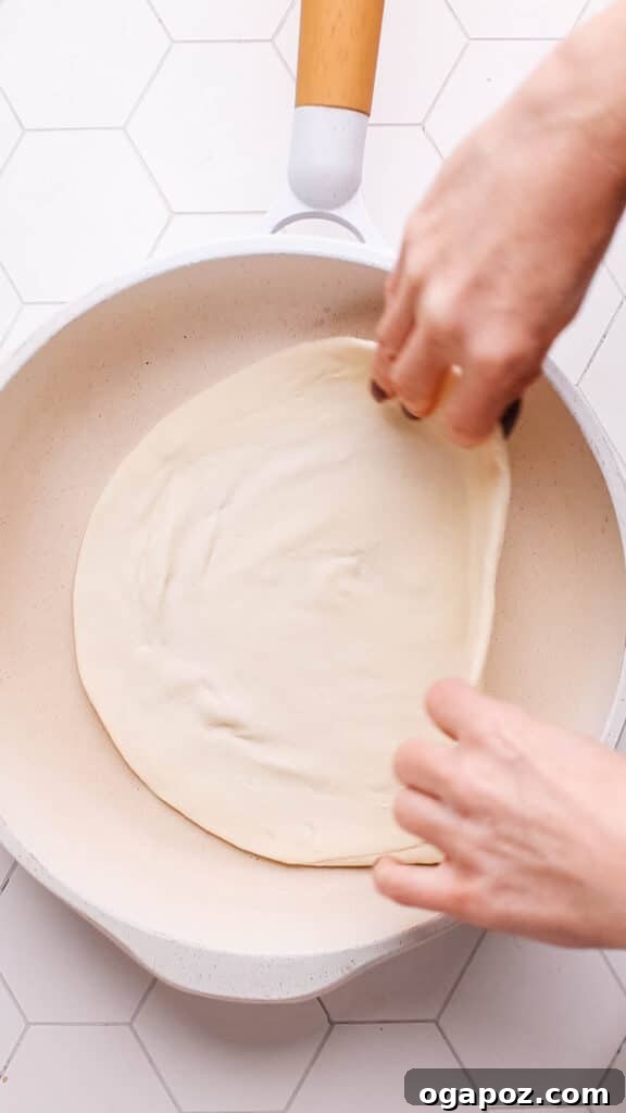 Golden Flaky Paratha Bread 16 Cooking the paratha in a pan.