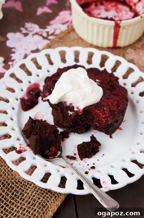 Chocolate Raspberry Invert Cakes 7 Close-up of a chocolate raspberry upside-down cake with whipped cream.