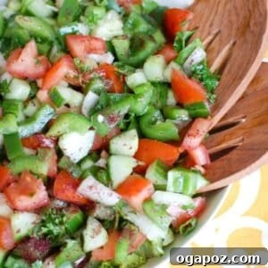 Easy Lebanese Salad in white bowl with wooden spoons