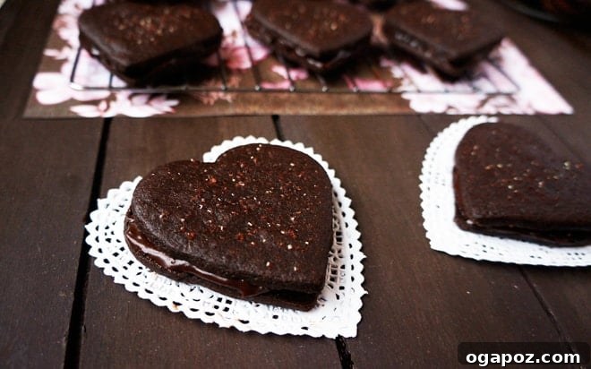 Double Chocolate Fudge Sandwich Cookies 2 Heart-shaped chocolate fudge sandwich cookies with red sparkly sugar, perfect for Valentine's Day