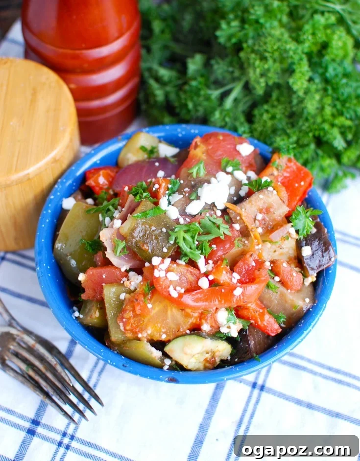 A large baking dish filled with colorful Greek Roasted Vegetables, or Briami, perfectly cooked and glistening in their tomato sauce, ready to be served.