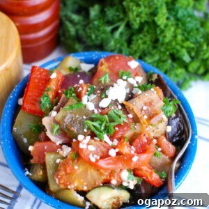 Plated Greek Roasted Vegetables (Briami) with fresh herbs and feta.
