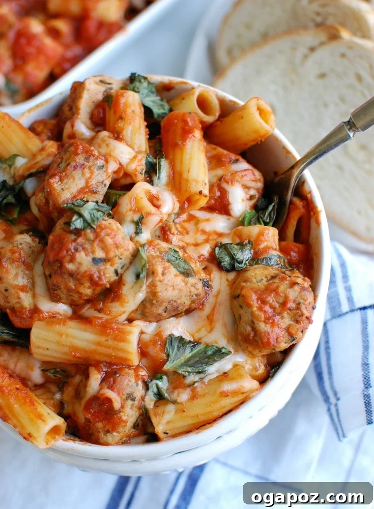 Comforting Baked Rigatoni with Tender Chicken Meatballs 2 Easy Baked Rigatoni with Chicken Meatballs, a hearty Italian-style pasta bake, served in a skillet.