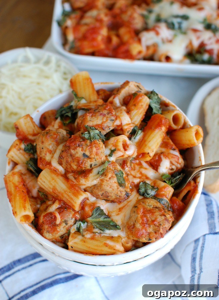 Comforting Baked Rigatoni with Tender Chicken Meatballs 5 A close-up of Easy Baked Rigatoni with Chicken Meatballs, freshly baked and garnished.