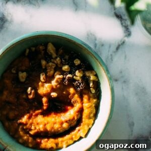 Overnight Carrot Cake Steel-Cut Oats 4 A beautifully presented bowl of Carrot Cake Slow-Cooker Steel-Cut Oats, garnished with toasted walnuts and a sprinkle of cinnamon, ready for a cozy breakfast.