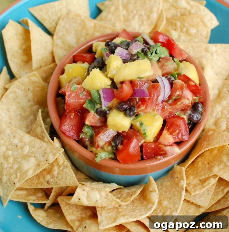 Close-up of vibrant Mango and Black Bean Salsa, showcasing diced mango, black beans, creamy avocado, and red onion