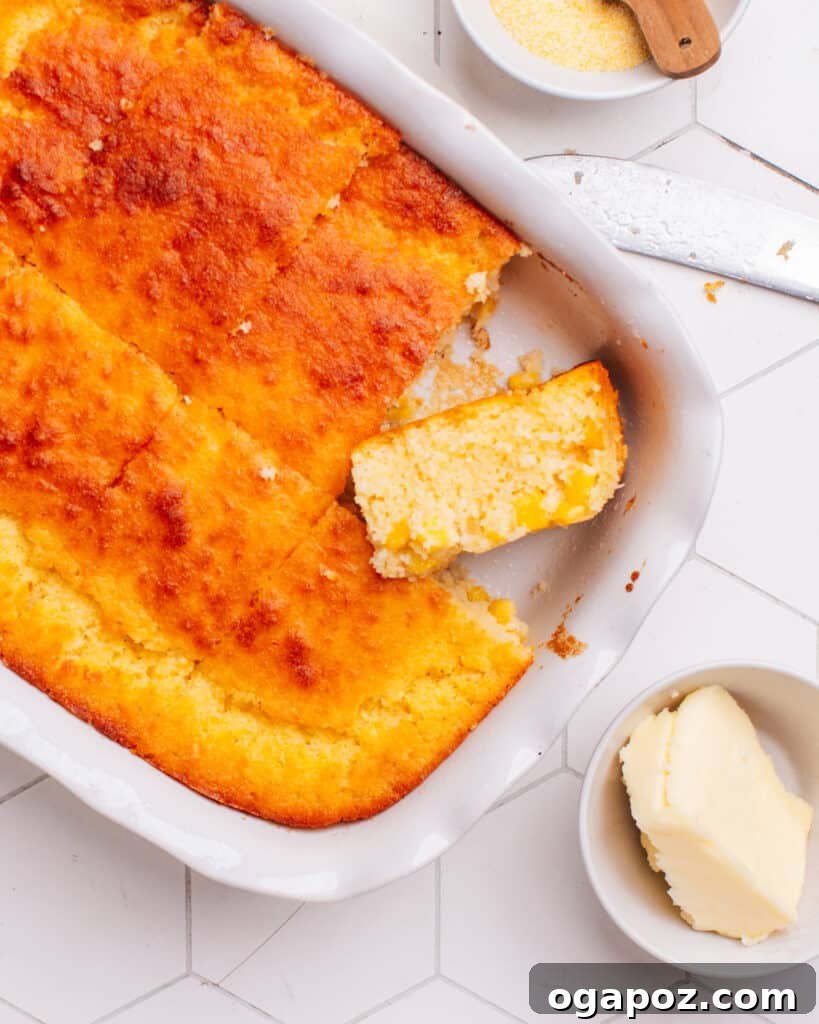 Golden Cornbread Delight 3 Cornbread casserole with a piece cut out.