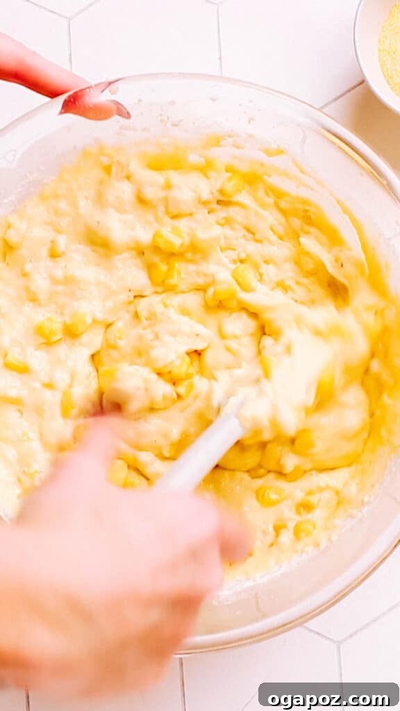 Golden Cornbread Delight 5 Stirring corn into cornbread casserole.