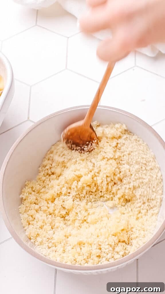 Classic Velvety Baked Macaroni and Cheese 13 Mixing breadcrumbs, melted butter, and dried parsley in a bowl for the macaroni and cheese topping.