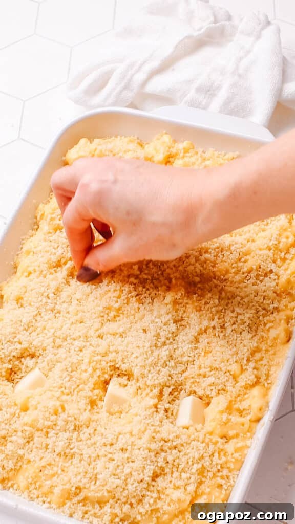 Classic Velvety Baked Macaroni and Cheese 15 Adding cubes of extra cheese to the top of old fashioned macaroni and cheese before baking.