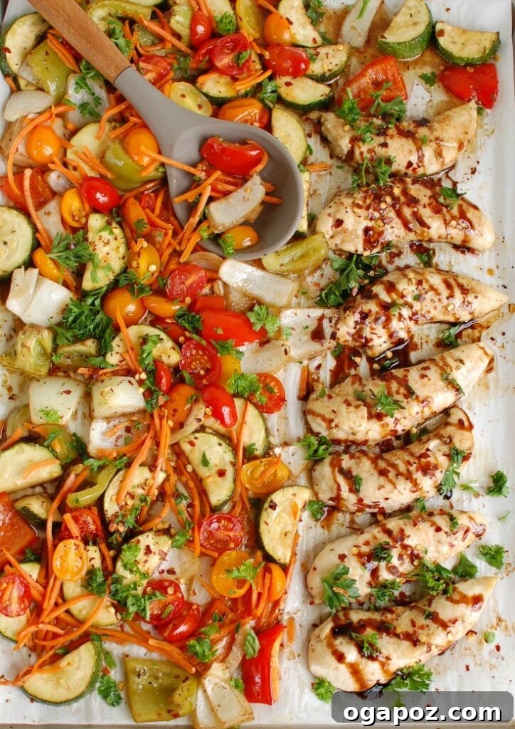 Sticky Balsamic Chicken & Roasted Veggies 3 Uncooked Sheet Pan Honey Balsamic Chicken Tenders and Vegetables arranged on a baking pan before roasting, showing fresh ingredients.