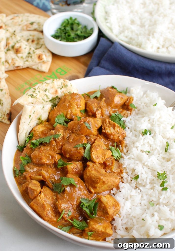 Meltingly Tender Slow Cooker Butter Chicken 3 Slow Cooker Butter Chicken in a white bowl, garnished with cilantro