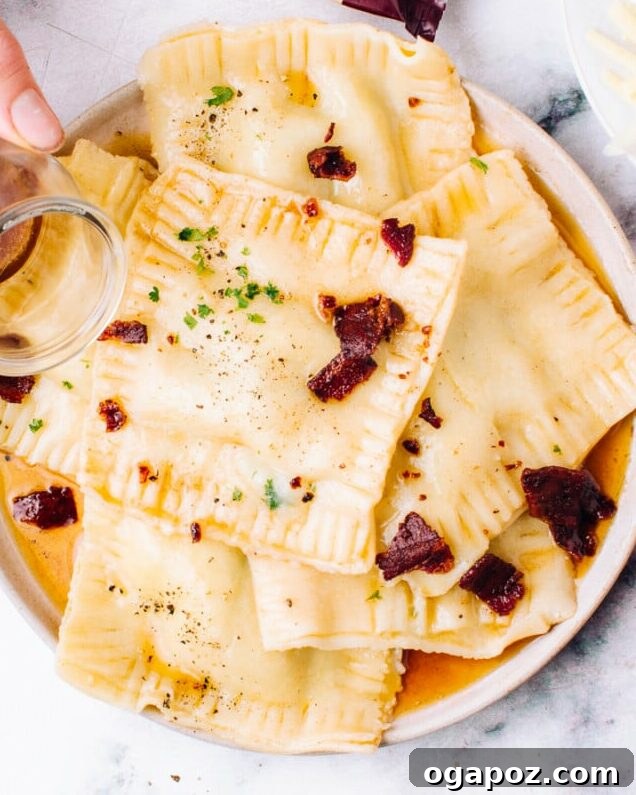 Handcrafted Pasta Perfection 3 Pouring browned butter over fresh homemade ravioli, garnished with herbs.