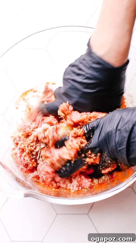 Lipton's Signature Meatloaf 5 Hands mixing the meatloaf ingredients in a bowl.