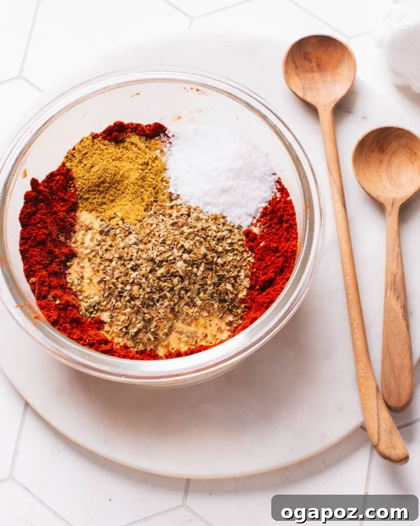 Secret Chili Seasoning Recipe 6 Hands carefully measuring and mixing various spices into a bowl, demonstrating the simple process of making homemade chili seasoning.