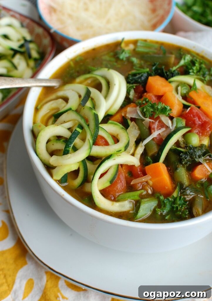 Vibrant Spring Minestrone 6 A close-up of a spoon scooping Spring Vegetable Minestrone, highlighting the chunky vegetables and rich broth.