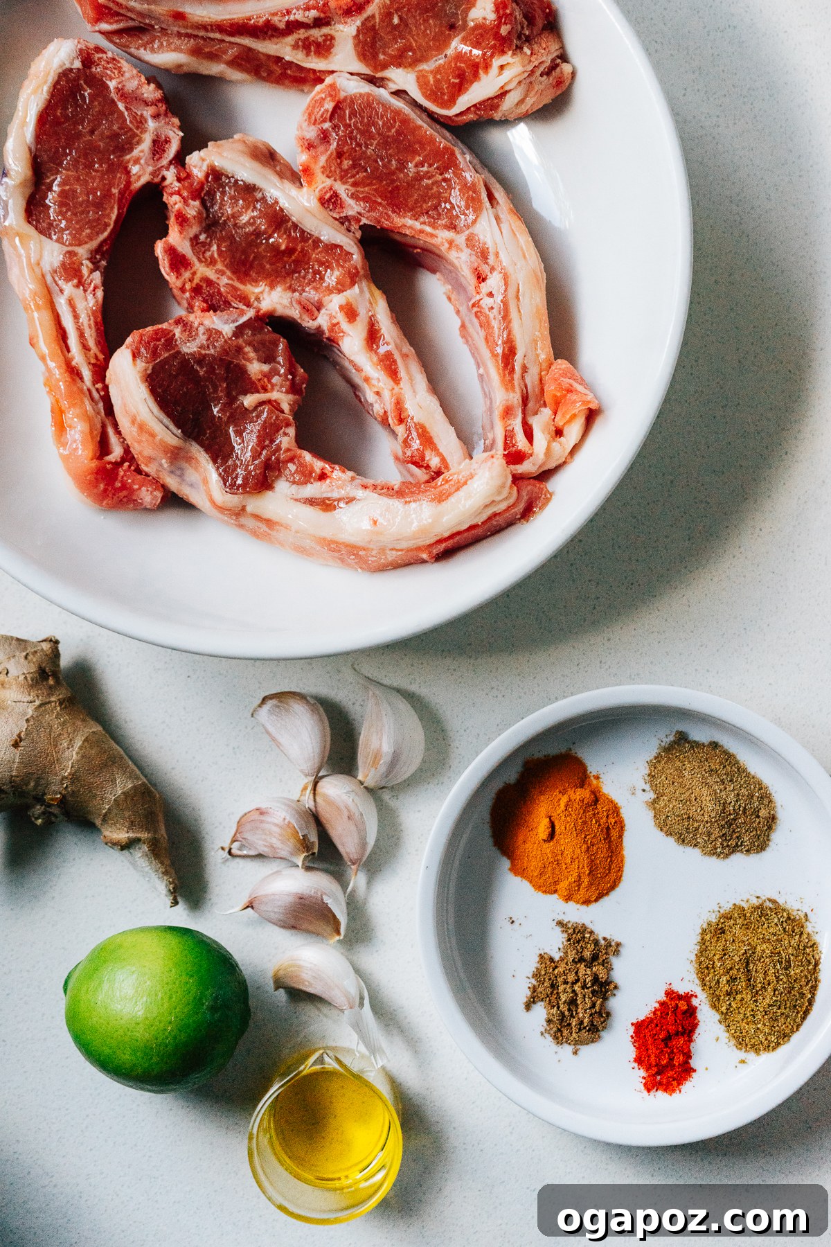 Maharaja's Lamb Chops 3 A vibrant flat lay of all ingredients needed for Indian Lamb Chops, including fresh lime, garlic, ginger, and a variety of colorful ground spices.