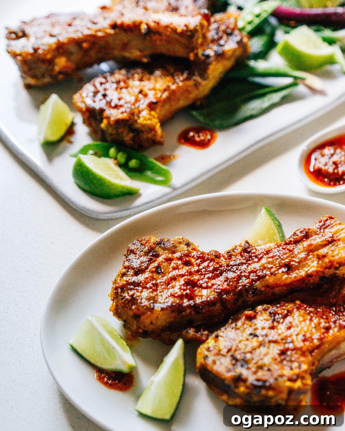 Maharaja's Lamb Chops 6 Plated Indian Lamb Chops, beautifully grilled and garnished with fresh lime wedges, ready to be served.