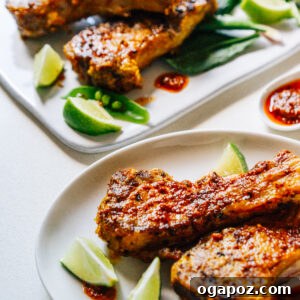 Indian Lamb Chops on plates with lime wedges.