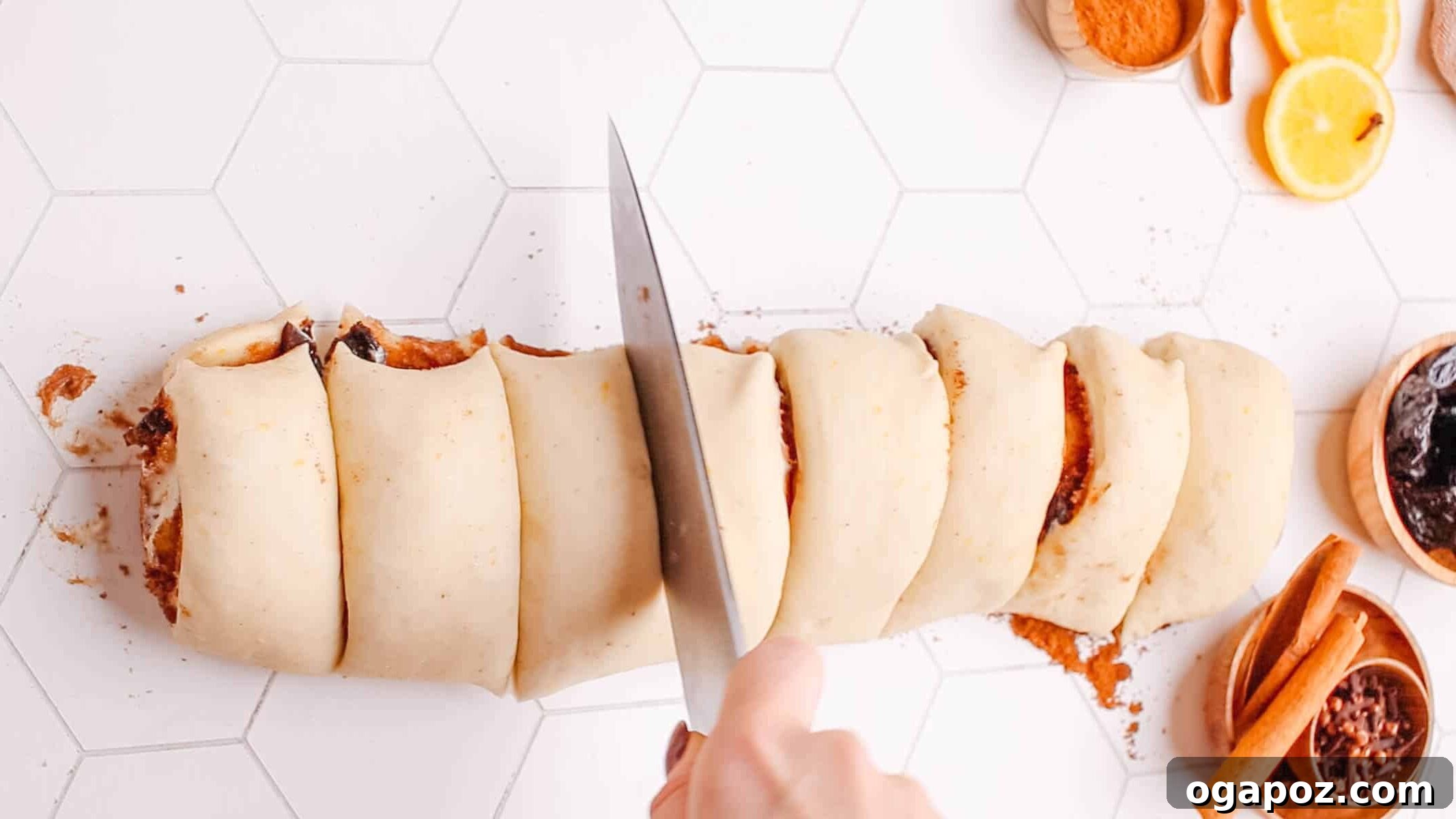 Sweet Cinnamon Swirls with Raisins 8 A baker's hands gently slicing the tightly rolled cinnamon roll dough into individual portions.