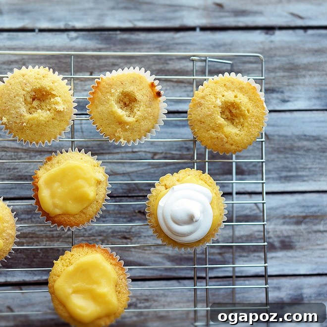 Zesty Coconut Lemon Cloud Cupcakes 5 A tray of finished lemon-curd filled coconut cupcakes