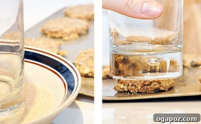 A close-up of cookie dough flattened with a sugared glass.