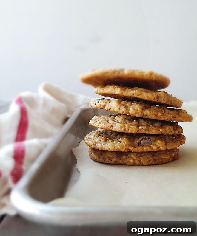 A stack of crunchy oatmeal cookies on a baking sheet, ready to be enjoyed.