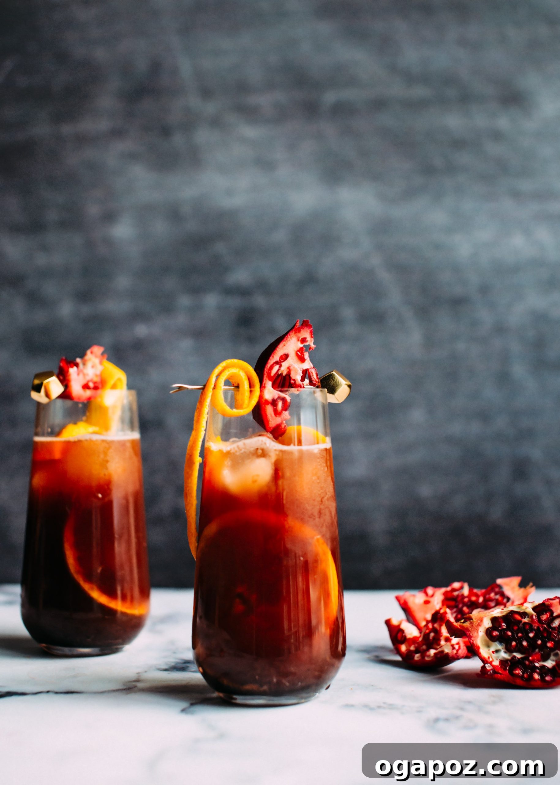 A pitcher of festive Christmas Sangria with orange slices and pomegranate arils, ready for a holiday party.