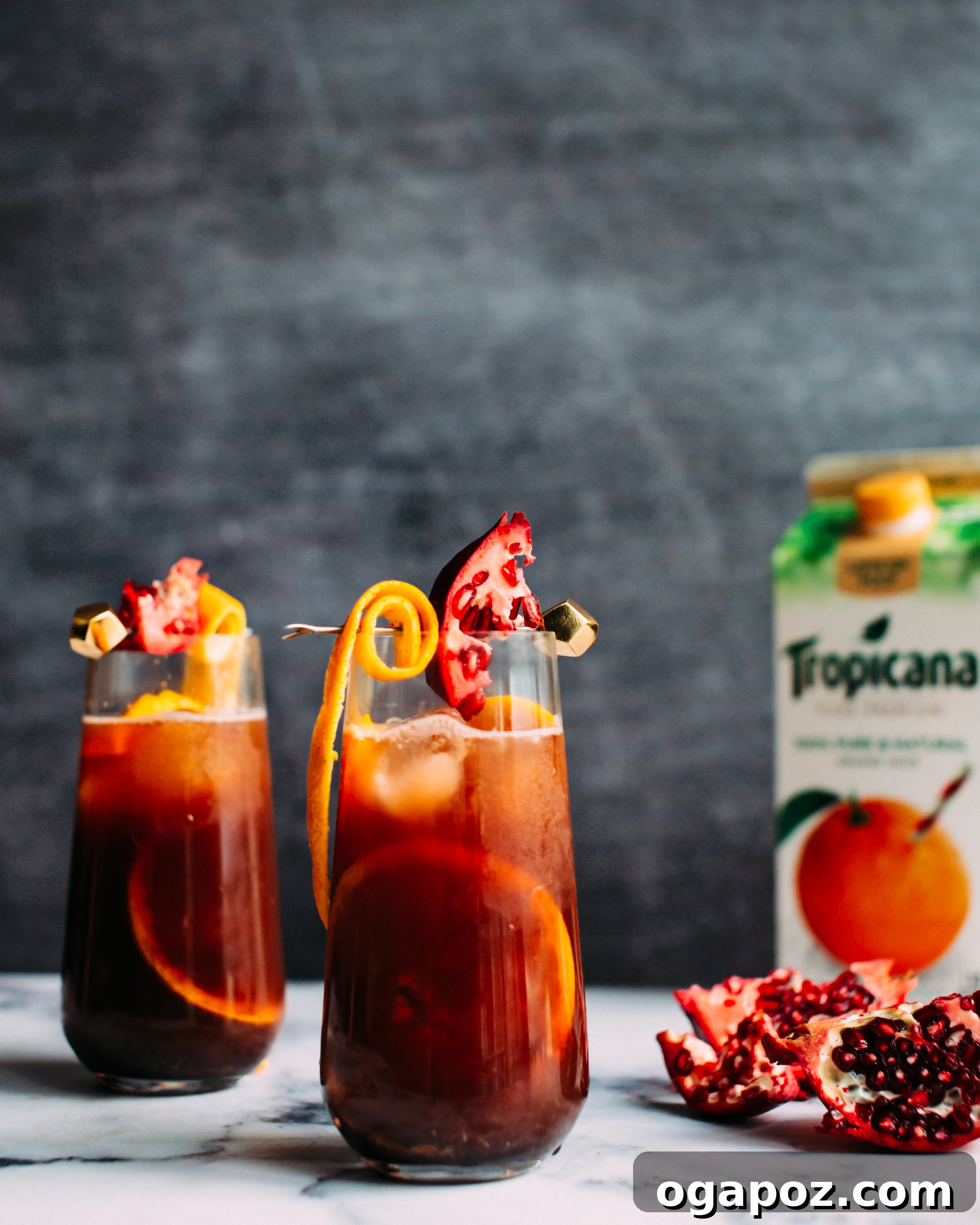 A close-up of a festive Christmas Sangria cocktail in a glass with a garnish.