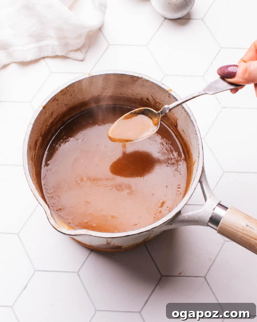 Tender Meatloaf, Velvety Brown Gravy 14 Gravy in a pot with a spoon.