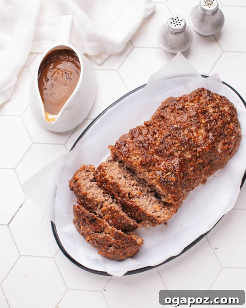 Tender Meatloaf, Velvety Brown Gravy 17 Sliced meatloaf with gravy next to it.