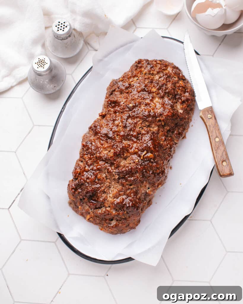 Tender Meatloaf, Velvety Brown Gravy 8 Baked Meatloaf on a serving plate.