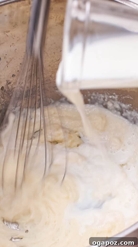 Liquid Gold Mac and Cheese Sauce 7 Adding milk to butter and flour mixture in saucepan.