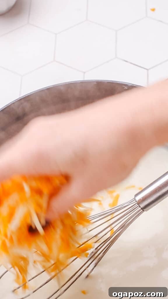 Liquid Gold Mac and Cheese Sauce 8 Adding cheddar cheese to sauce for macaroni and cheese.